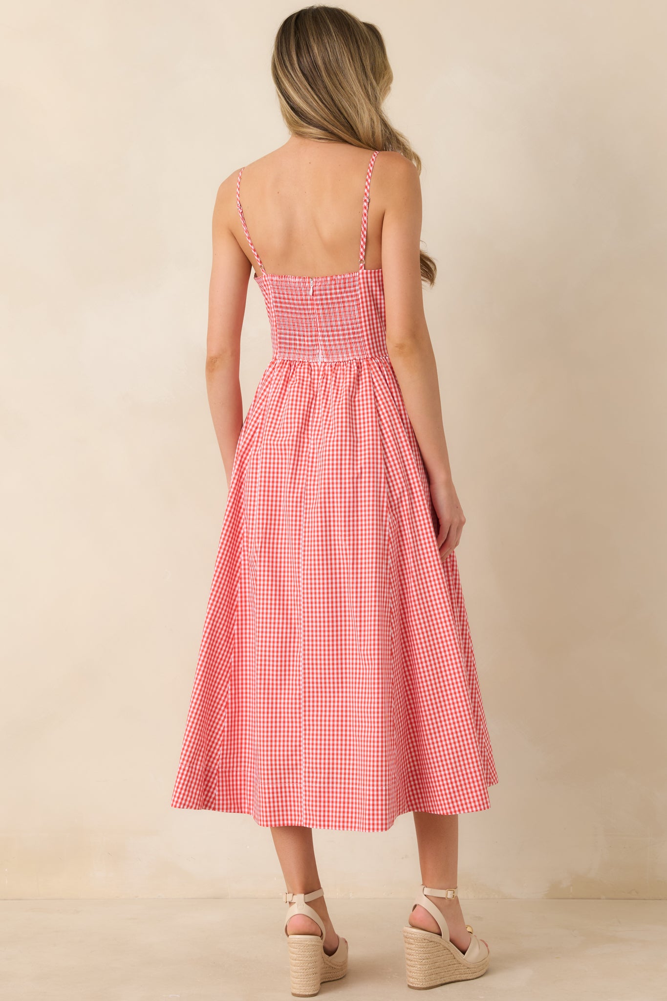 Rear view of striped midi dress with delicate straps and softly flowing midi-length silhouette.