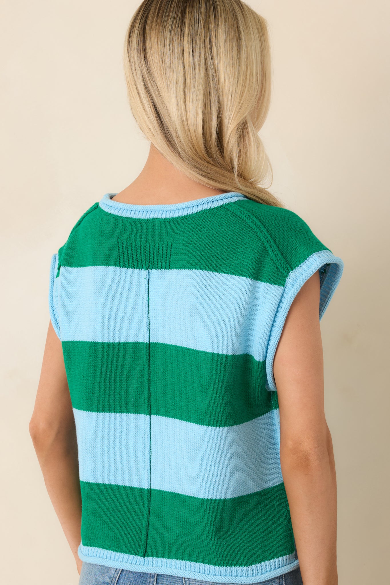 Rear view of striped knit top with cap sleeves and relaxed fit.
