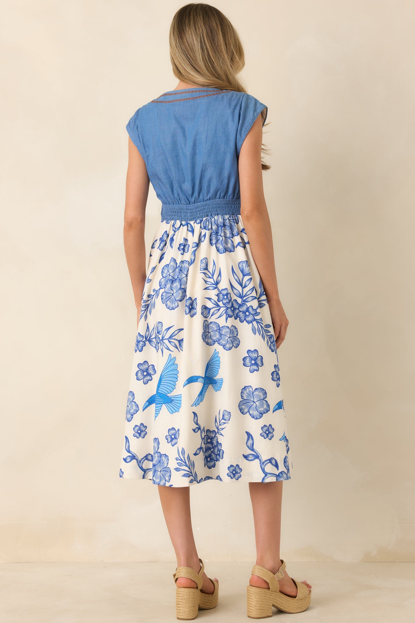 Rear view of the denim-inspired dress highlighting the fitted waist and clean, streamlined silhouette.