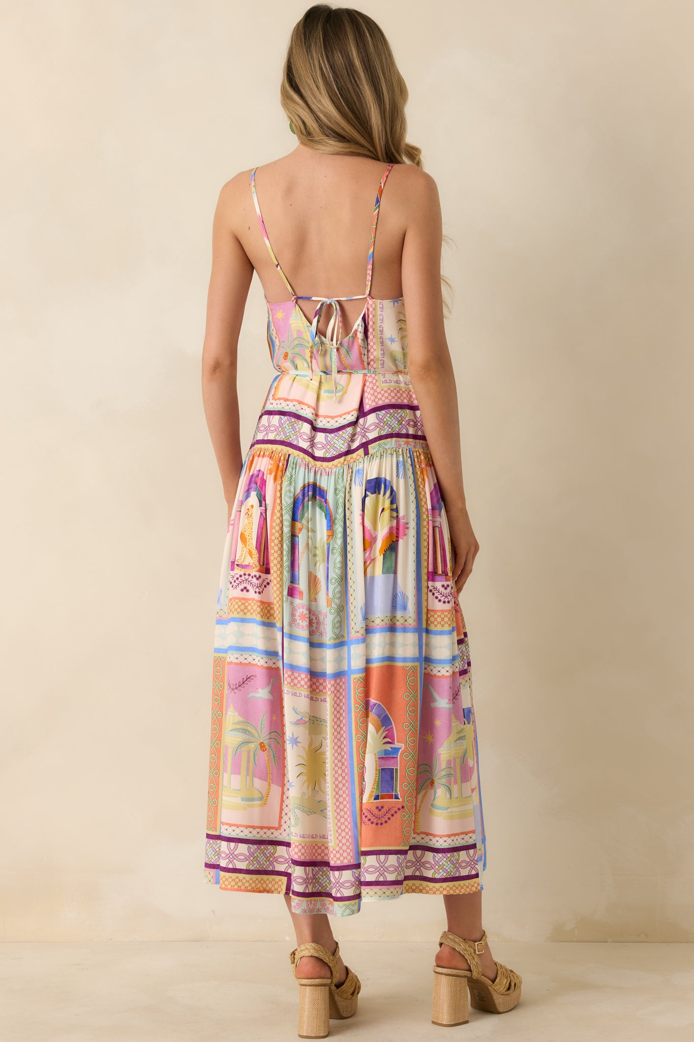 Rear view of the tropical print maxi dress featuring the low tie closure and tiered ankle-length skirt.