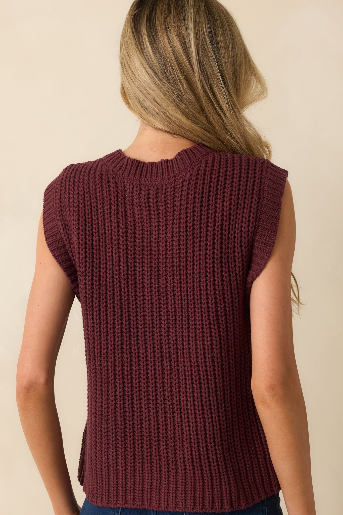 Rear view of the wine red vest showing the ribbed hem and relaxed silhouette.