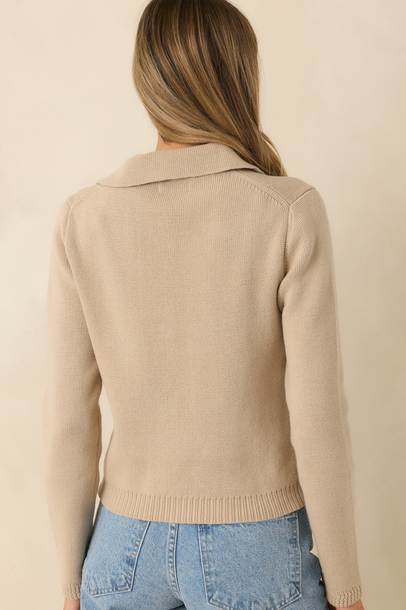 Rear view of the taupe cardigan displaying the smooth knit back, ribbed hem, and slightly tailored fit.