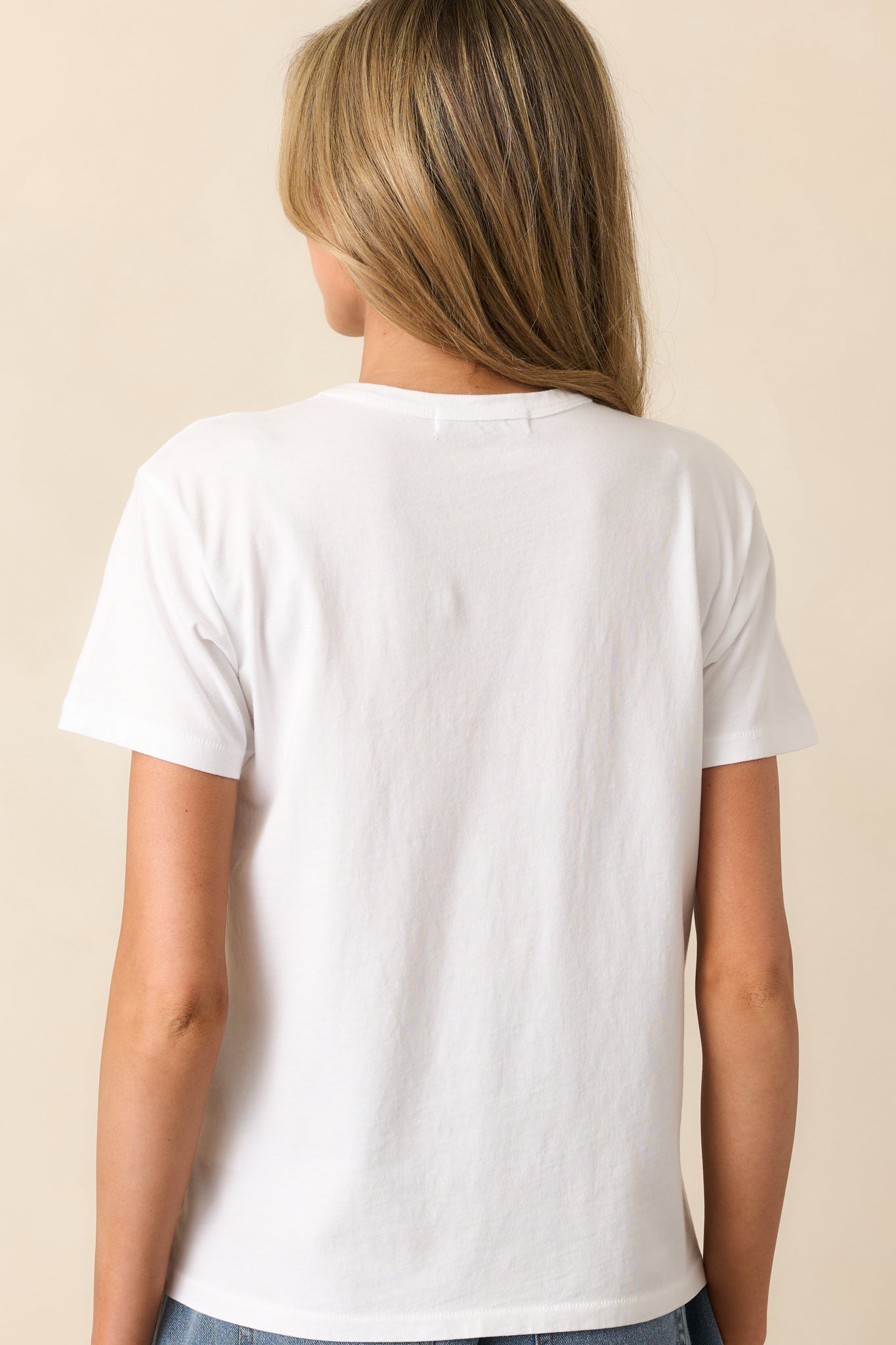The rear of this white tee features a clean, simple design with a relaxed drape for effortless wear.