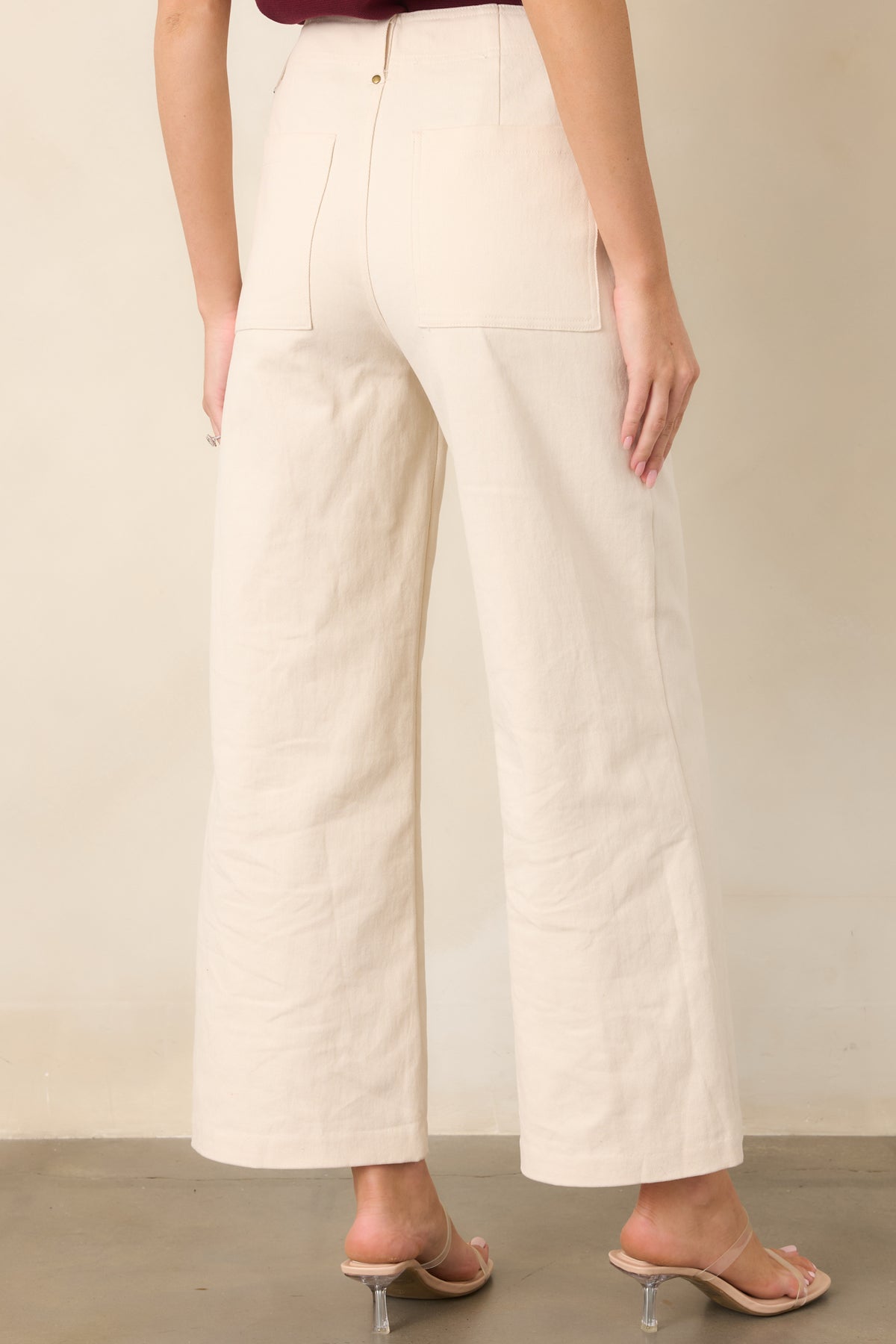 Rear view of the pants highlighting the high-rise waist and oversized back patch pockets.