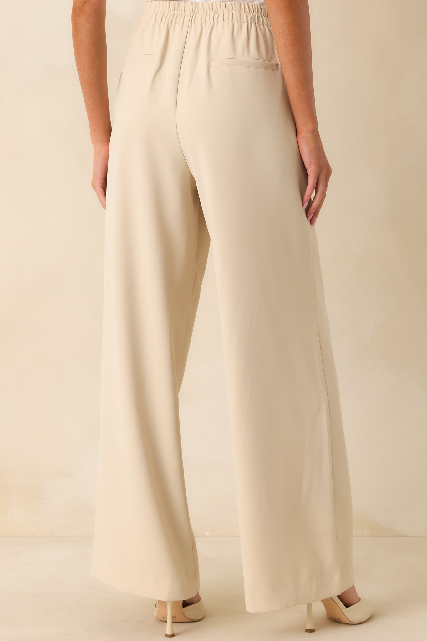 Rear view of the pants displaying the faux slit pockets and elastic waistband from behind.