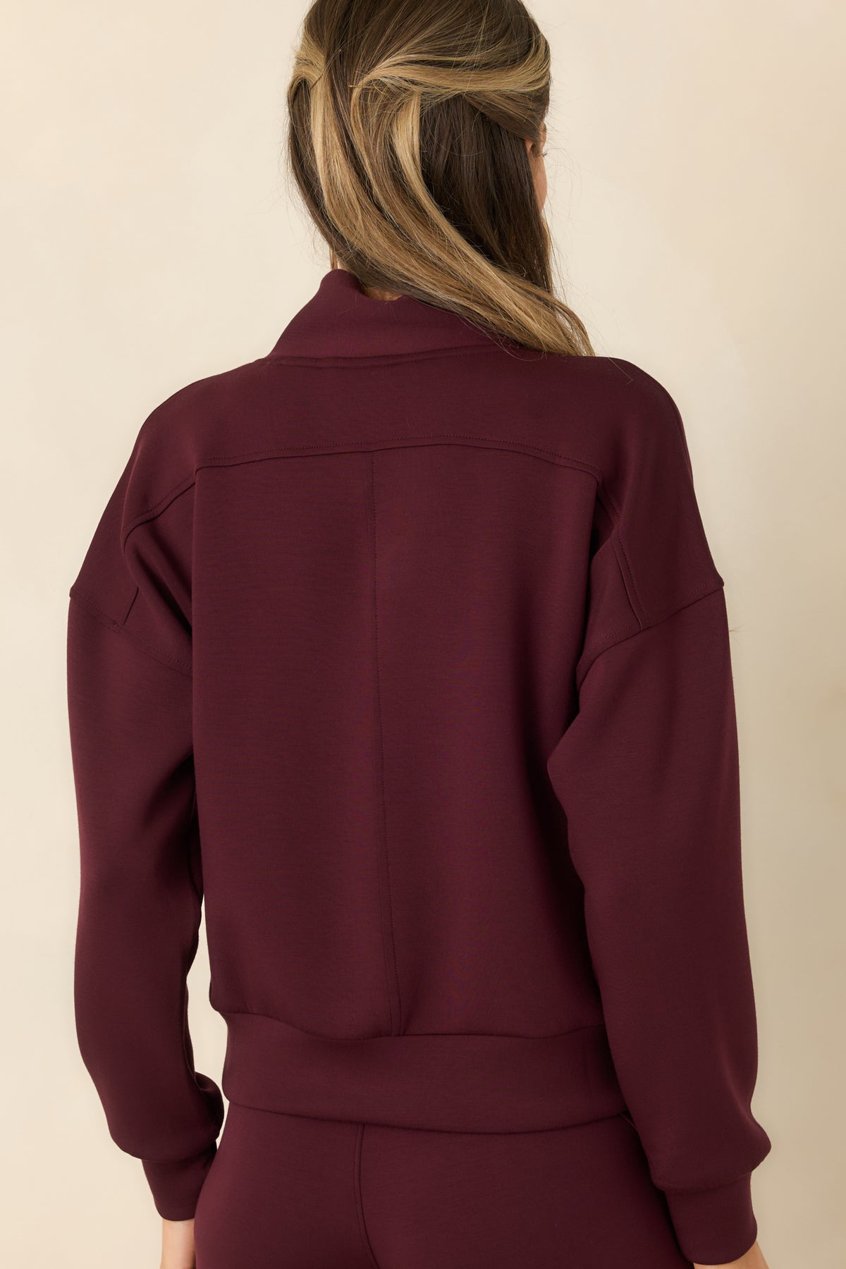Rear view of the relaxed spacer-fabric pullover with dropped shoulders and long sleeves.