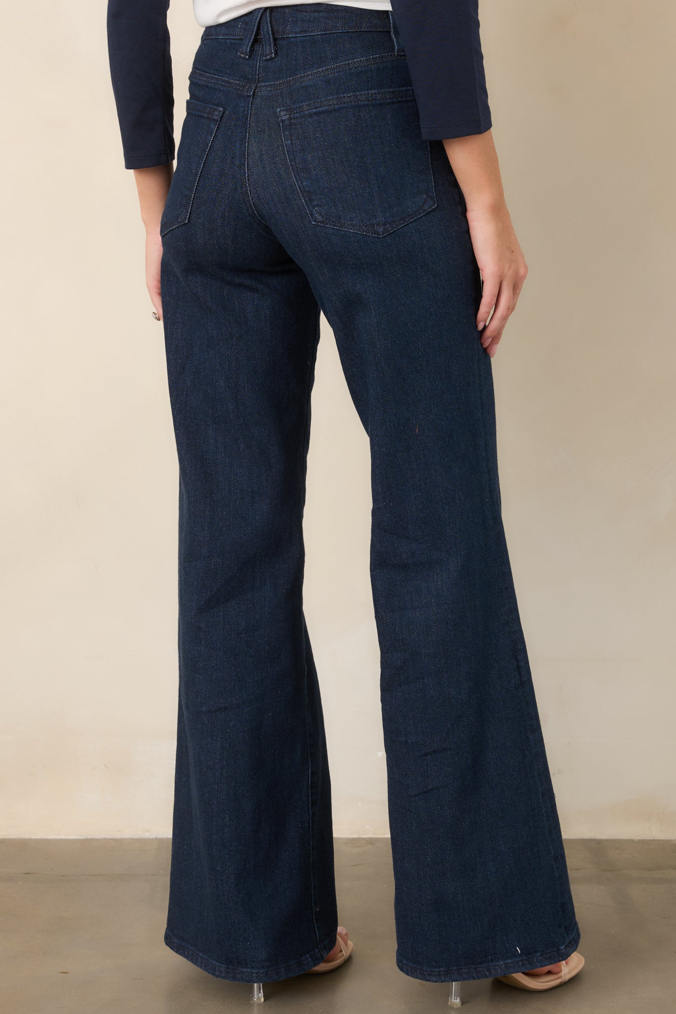 Rear view of the wide-leg jeans showcasing the relaxed full-length silhouette, belt loops, and two back pockets.