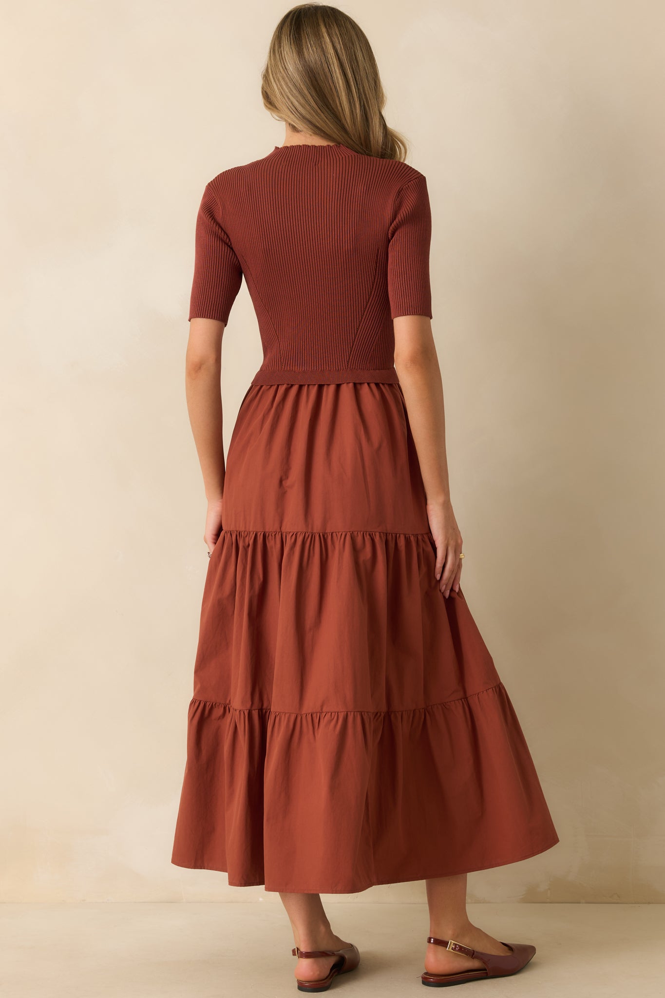 Rear view of the rust red maxi dress showing the tiered skirt and short sleeves from behind.