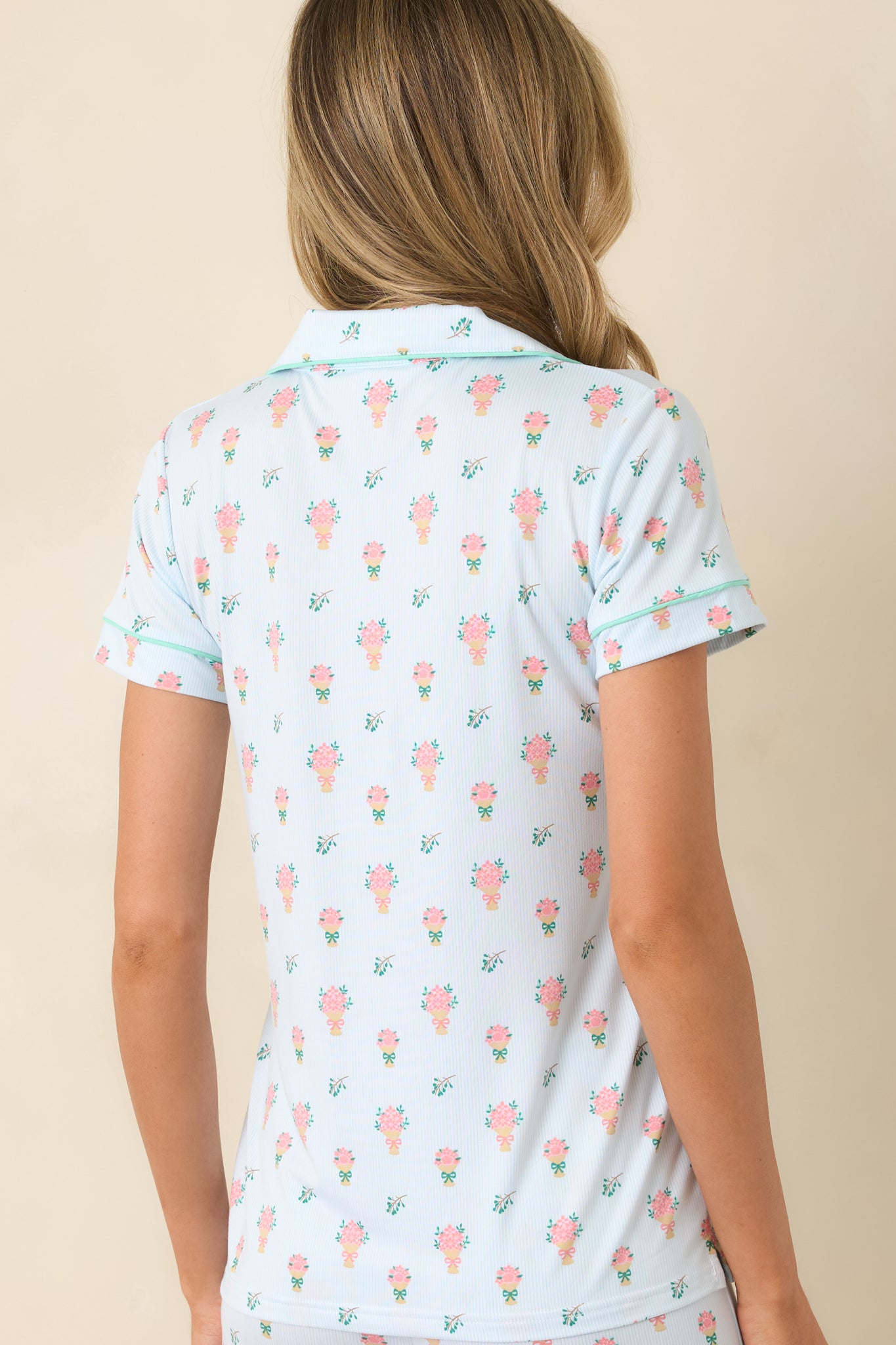 Rear view of the light green floral top showcasing the allover bouquet print and clean, uninterrupted silhouette.