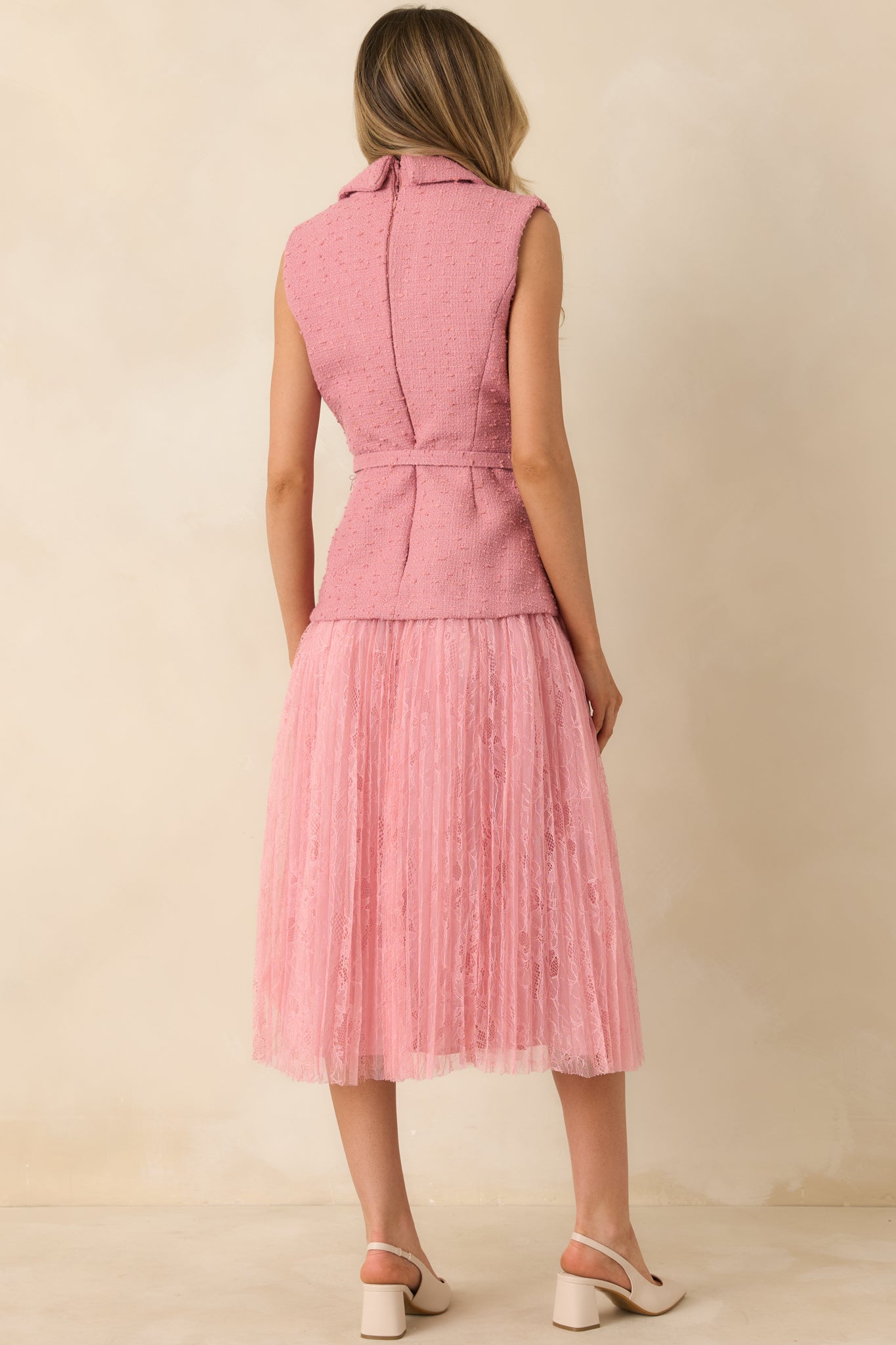 Rear view of rose pink midi dress showing concealed back zipper and softly structured silhouette.