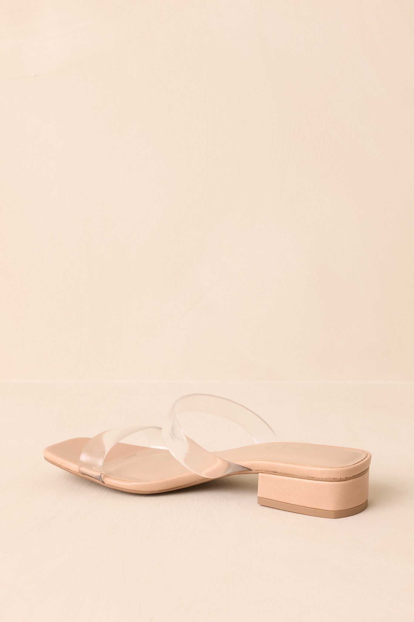 Rear view of open-toe heels showing short block heel and smooth sole.