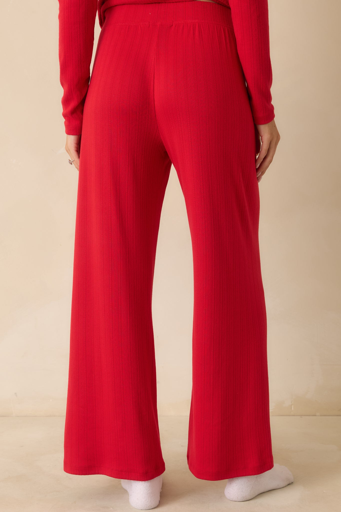 Rear view of red wide-leg pants, showing the flowy full-length silhouette and elastic high-rise waistband.