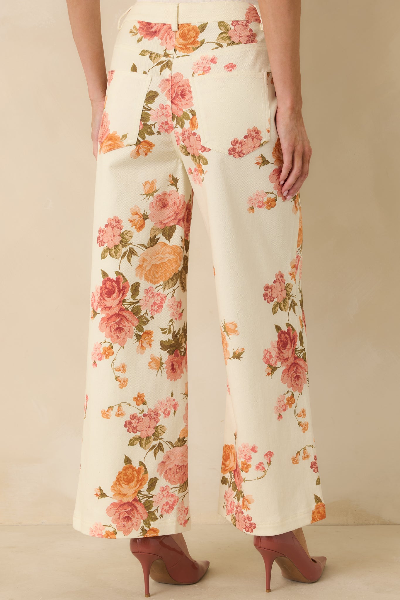 Rear view of the pink floral cotton pants showing the wide-leg fit, high-rise waist, and functional back pockets.