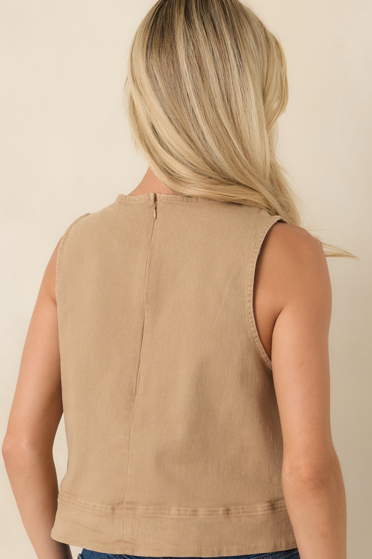 Rear view of the sleeveless denim top highlighting the relaxed A-line silhouette and concealed back zipper.