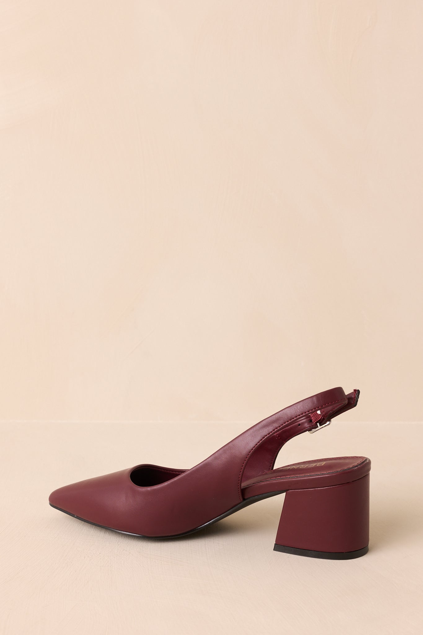 Rear view of wine red heels highlighting the slingback strap and block heel.