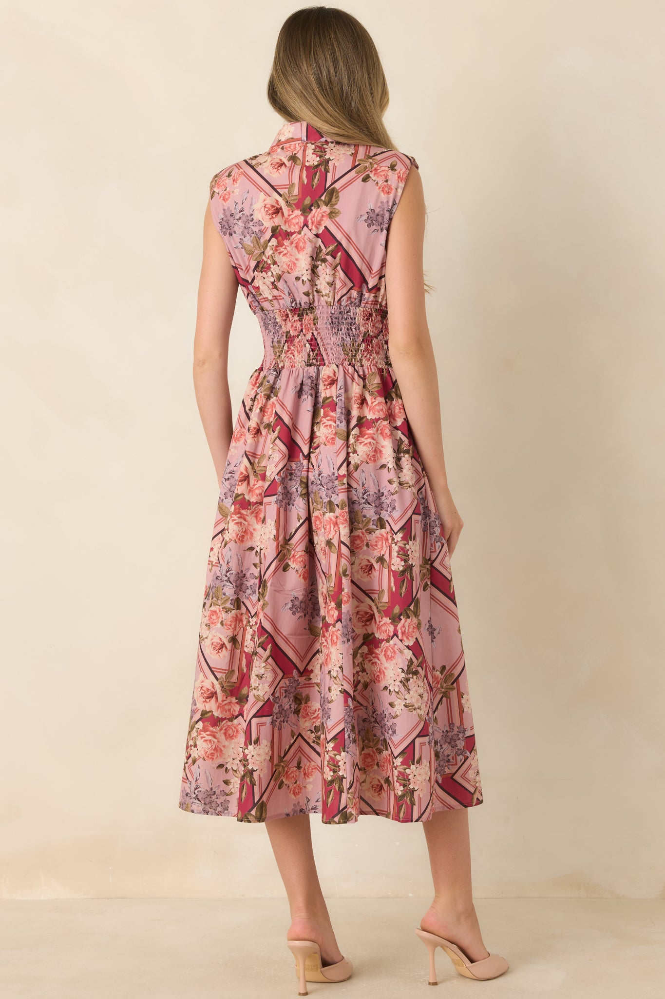 Rear view of the 100% cotton midi dress showcasing the sleeveless silhouette, smocked waist, and flowing full-length skirt.