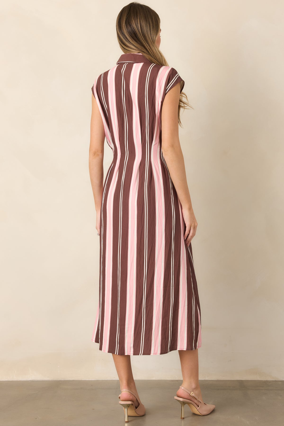 Rear view of the striped midi dress showcasing its tailored princess seams, fitted waist, cap sleeves, and softly flared skirt.
