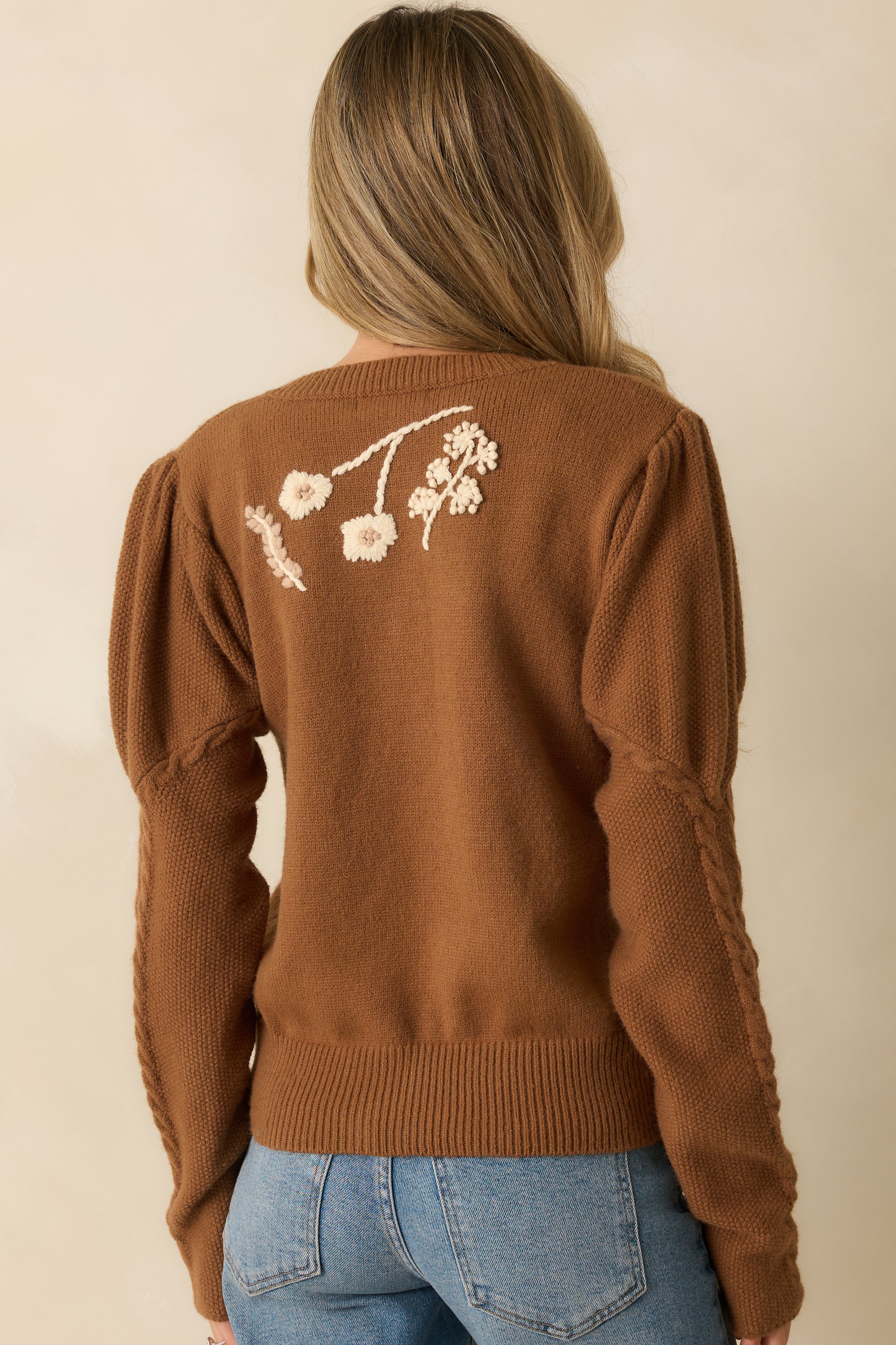 Rear view of the tiramisu brown knit cardigan showing smooth knit texture and embroidered details.