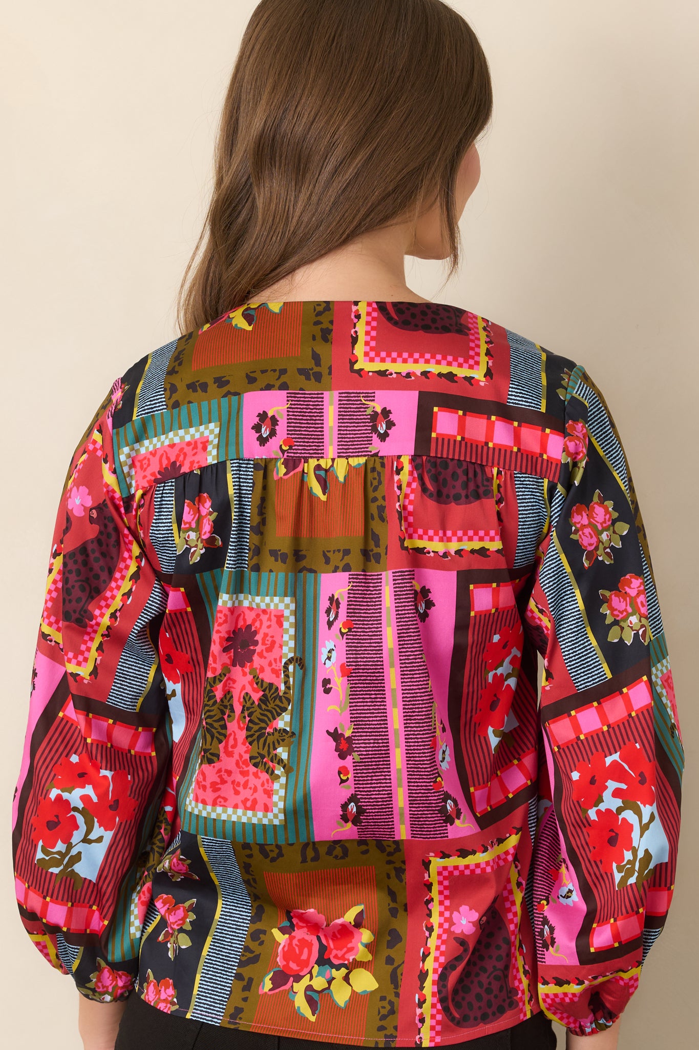 Rear view of the Vintage Vignette top showcasing its easy fit, voluminous three-quarter balloon sleeves, gathered cuffs, and eclectic patchwork-inspired print.