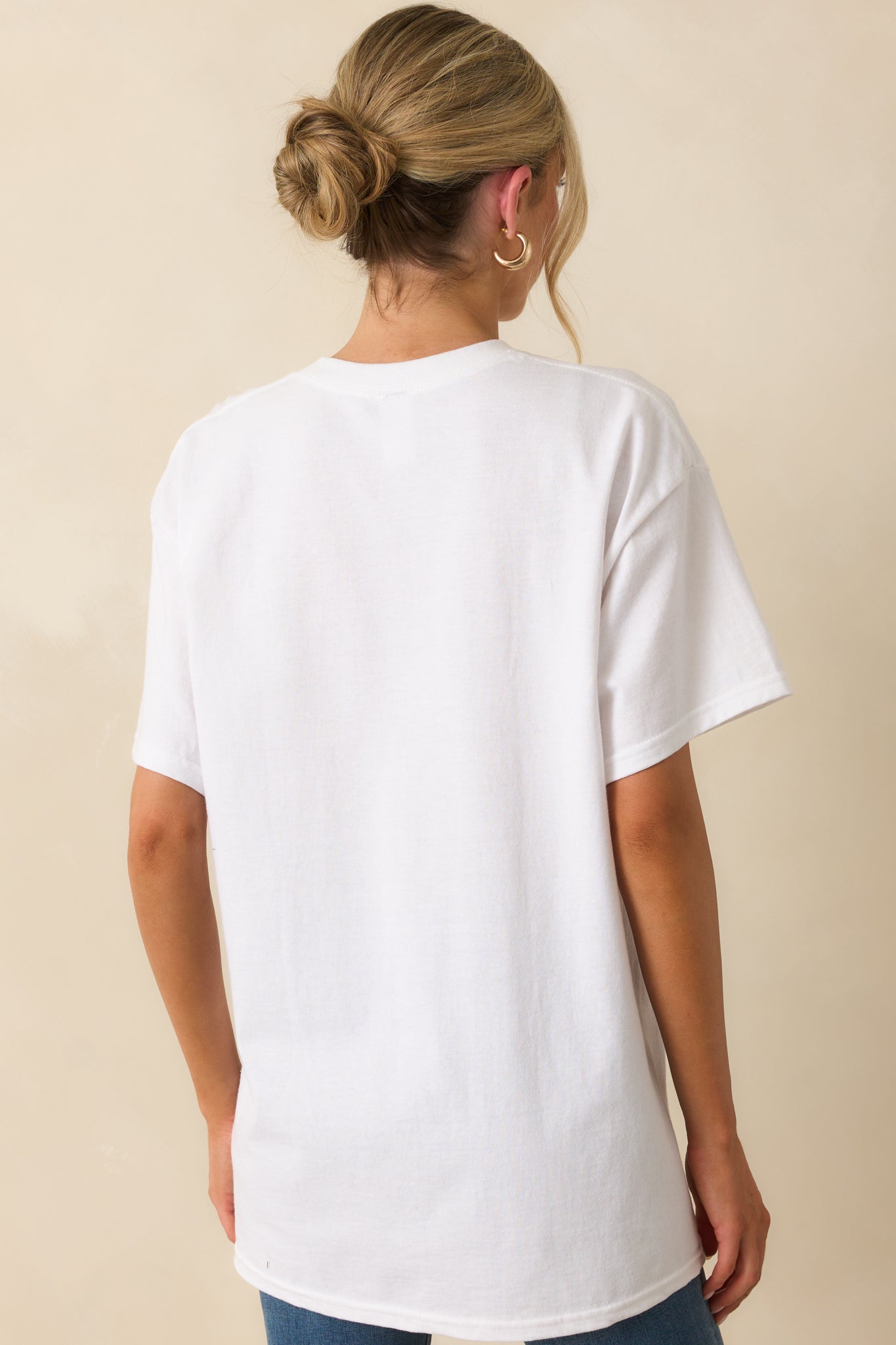 View from behind of the white tee, showing plain fabric and relaxed fit without any graphics.