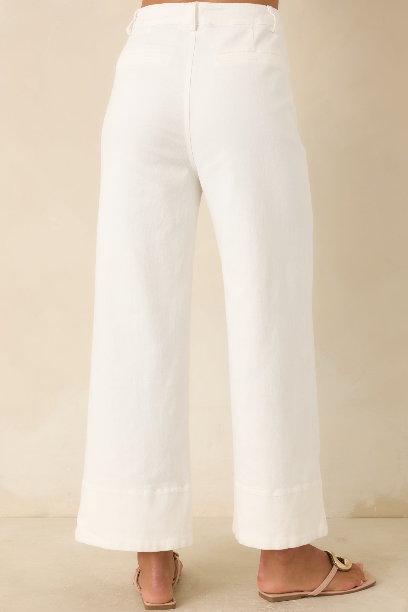 Rear view of the wide leg pants featuring a smooth high-rise fit, faux welt back pockets, and clean tailored finish.