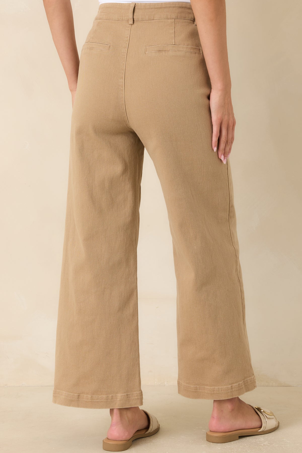Rear view of the ankle-length wide leg pants highlighting the faux welt pockets and structured back design.