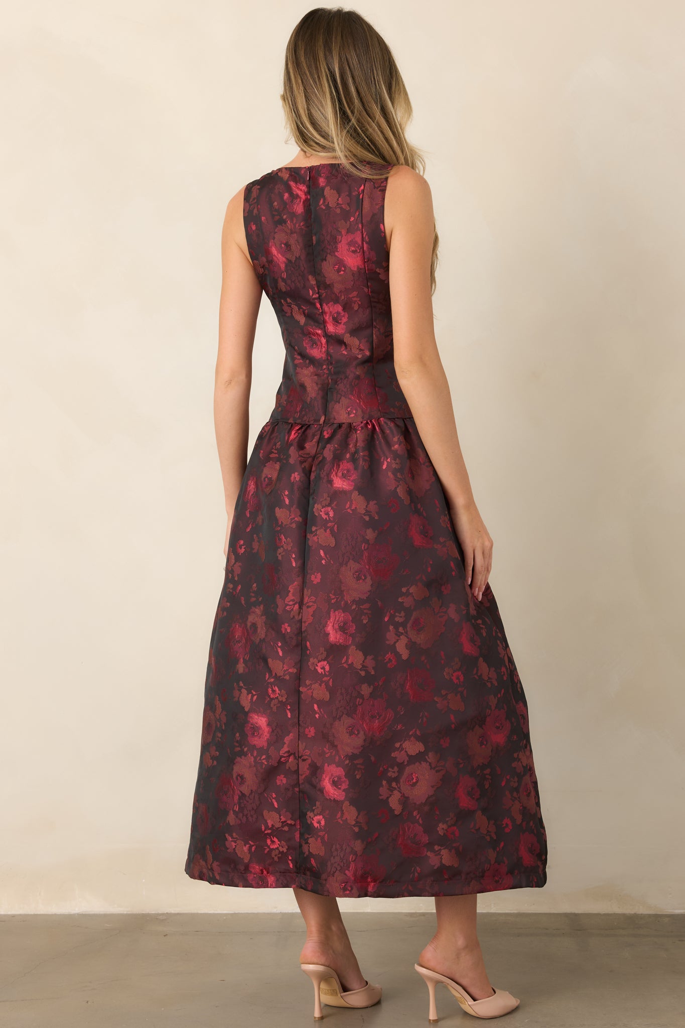 Rear view of the woven floral midi dress showcasing the sleeveless bodice, full gathered skirt, concealed zipper, and clean fit-and-flare silhouette.