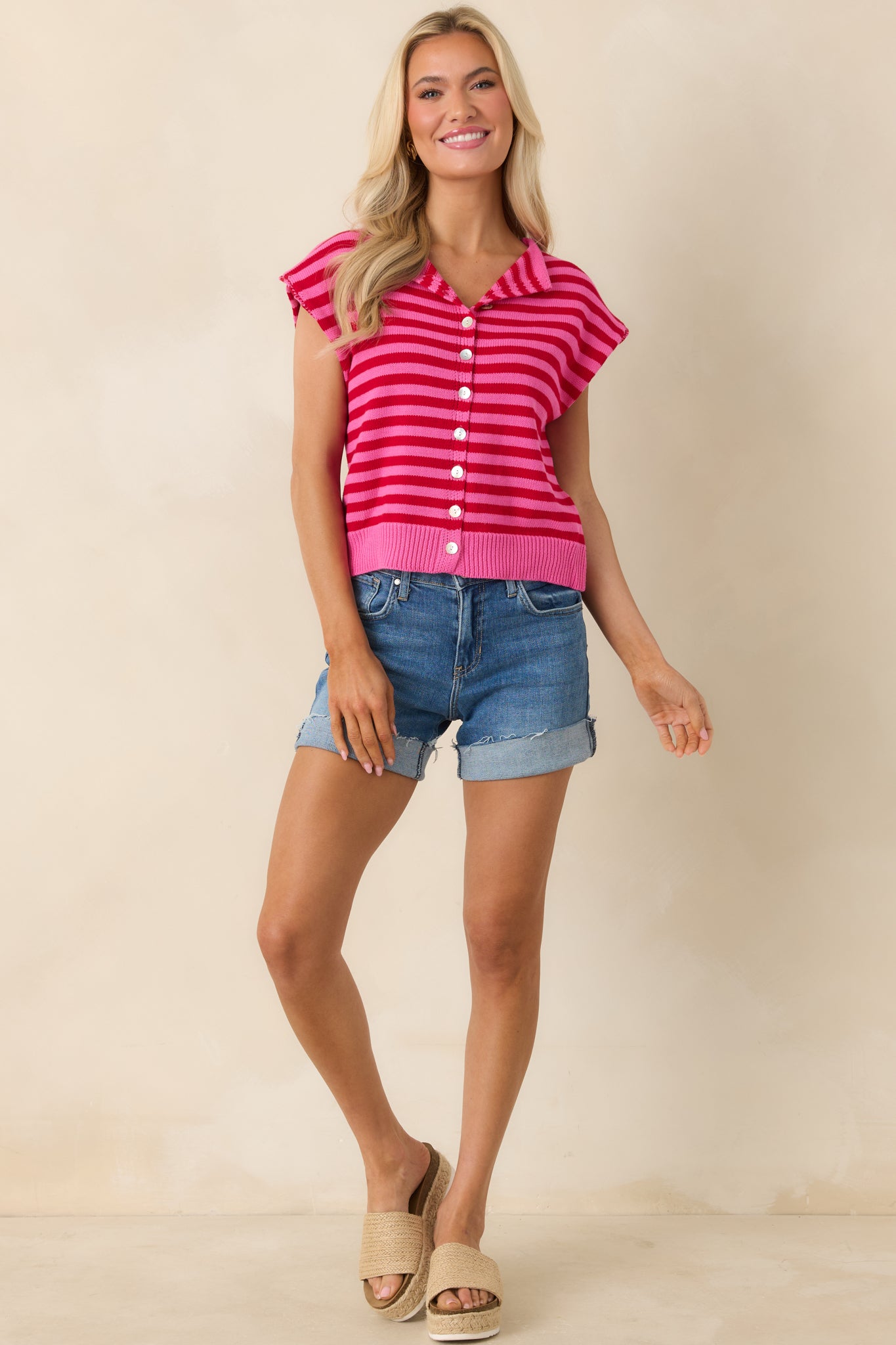Red and pink striped knit top with collared neckline and button front.