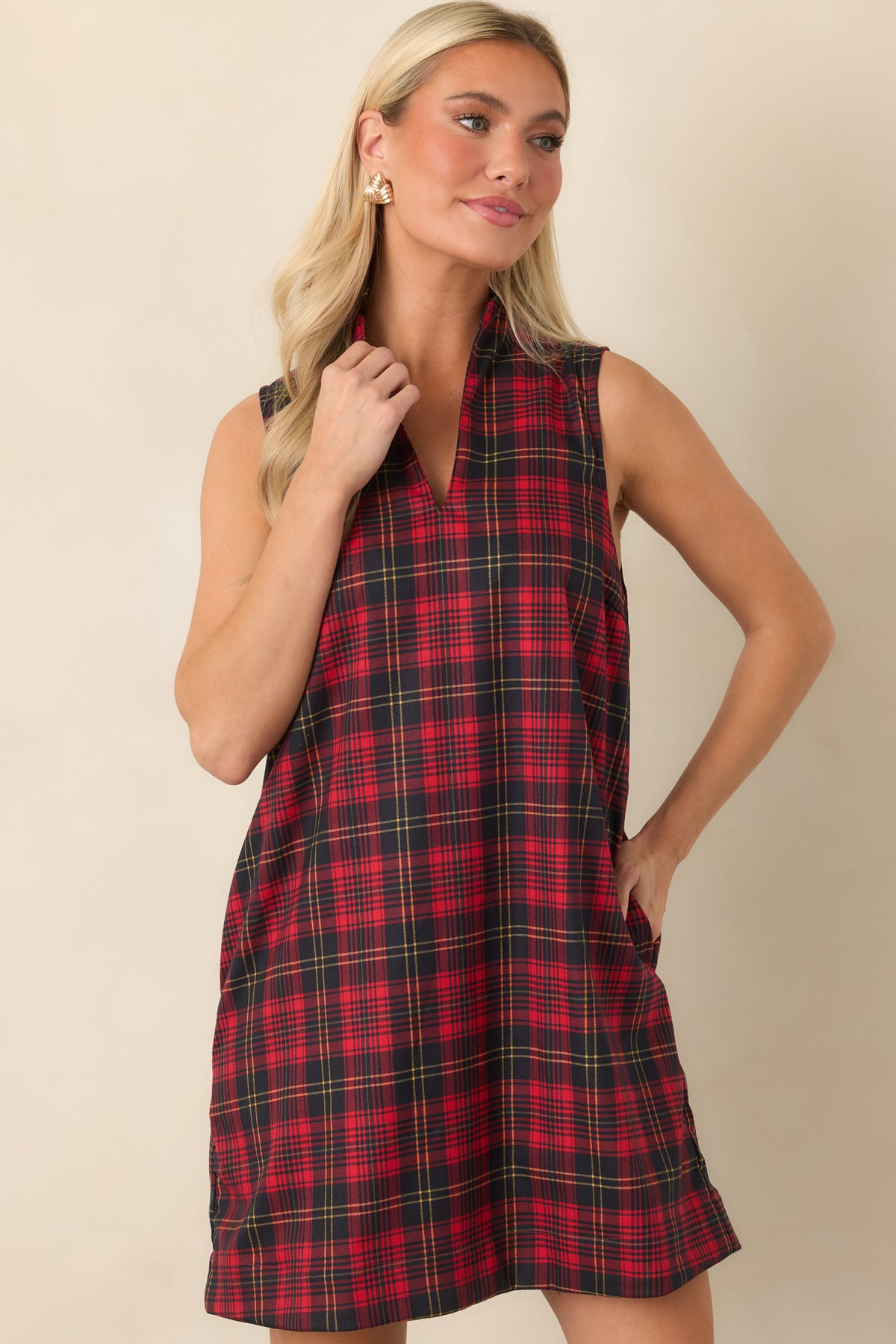 Red and black plaid dress featuring a structured standing neckline and sleeveless shift design.