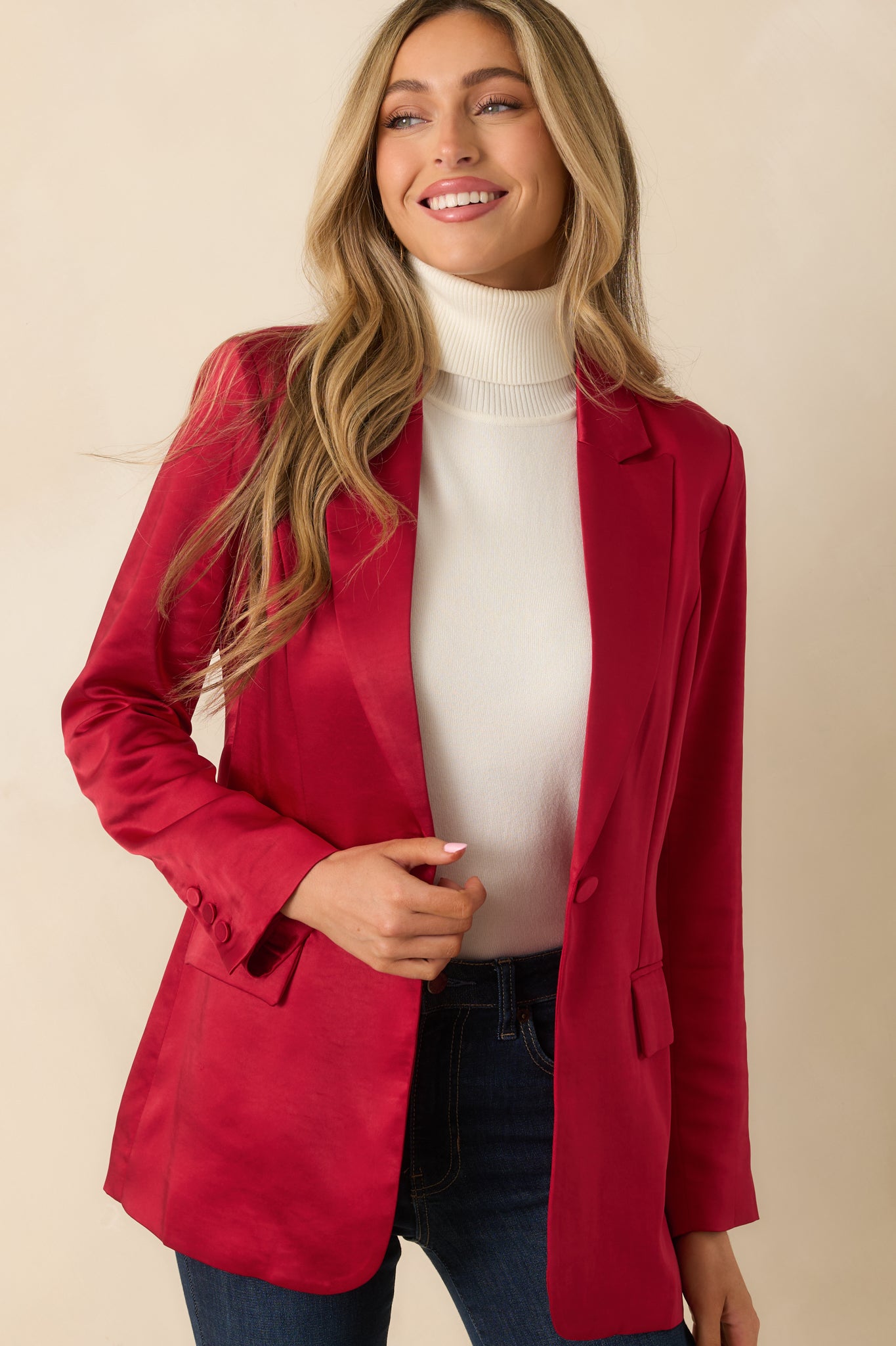 Upper front of the red blazer highlighting the notched lapel and button closure.