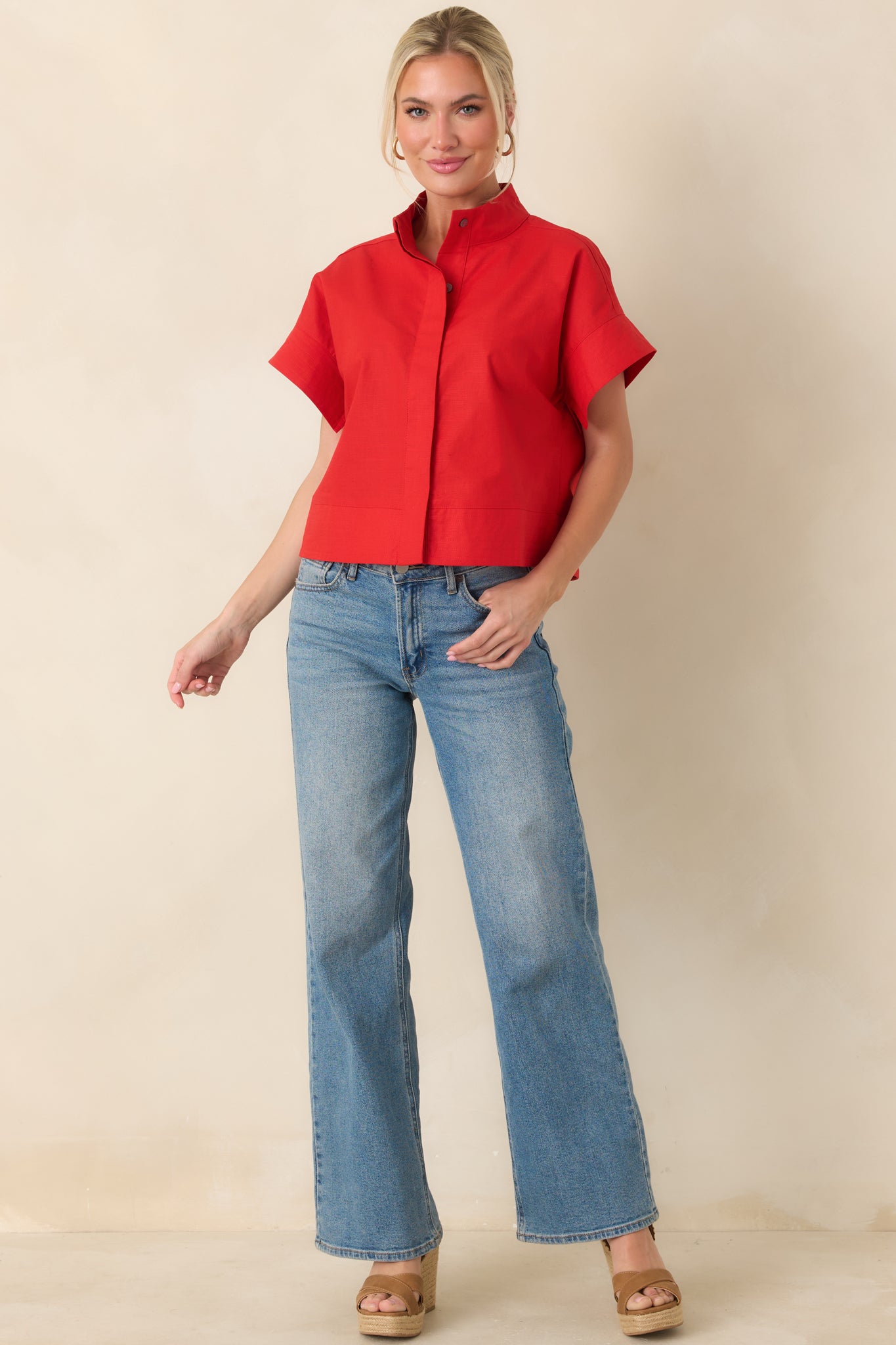 Red cotton-linen blend top with structured boxy silhouette, polished mock neckline, and short sleeves.