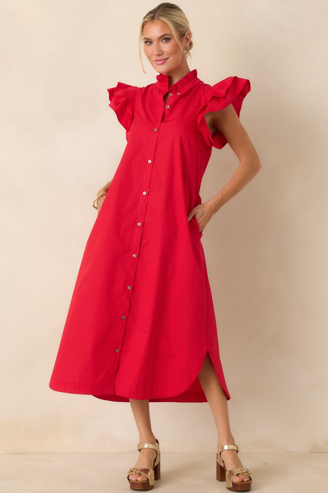 Red cotton midi dress with button-front closure, flutter sleeves, and functional side pockets.