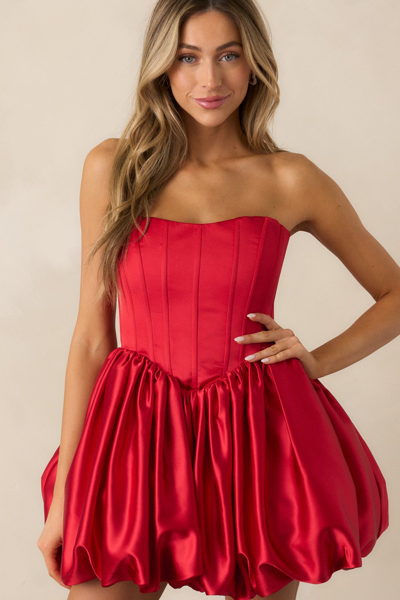 The red dress displayed from head to hem, highlighting the structured corset boning and flattering silhouette.