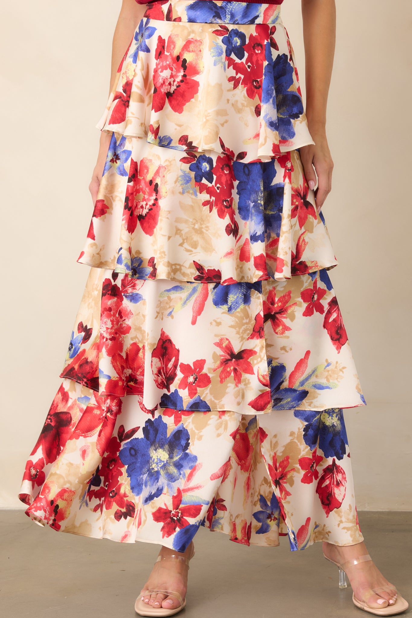 Front detail of the maxi skirt highlighting its vibrant red floral pattern and cascading tiered construction.