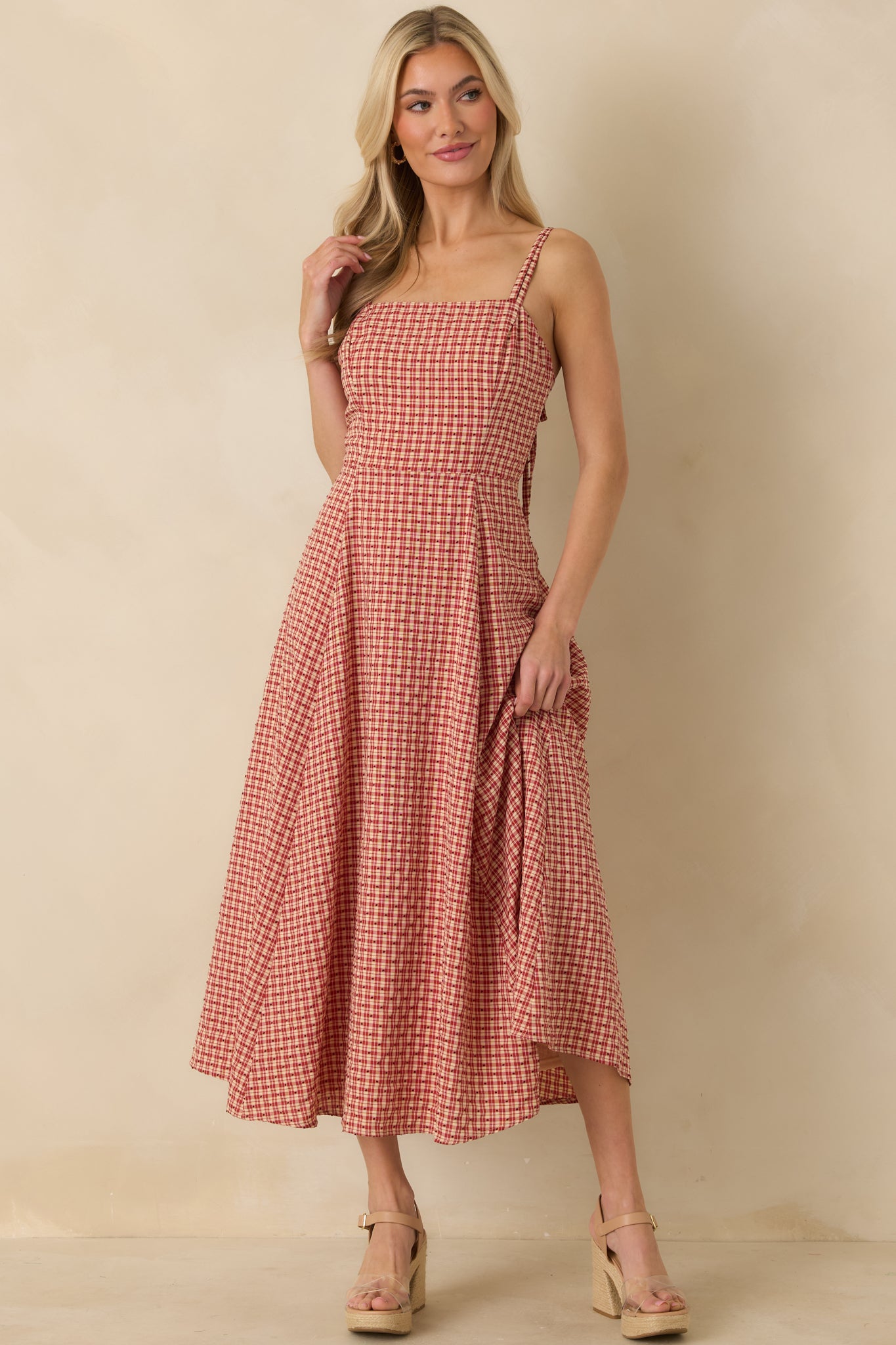 Front view of red gingham dress with embroidered polka dot pattern and full-length lined skirt.