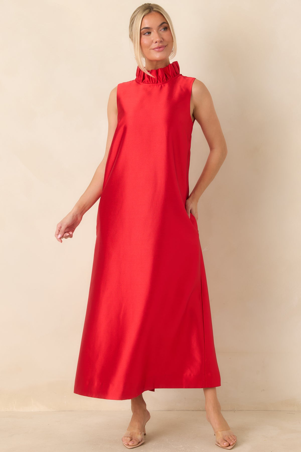 Bright red maxi dress showcasing a high ruffled neckline and a relaxed, floor-length silhouette.