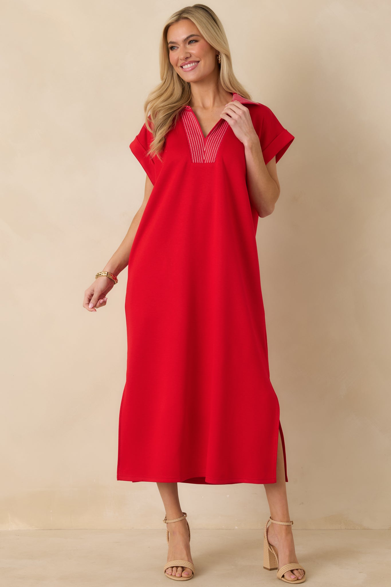 Red knit midi dress with a relaxed straight fit, V-neckline, and contrast stitch detailing.