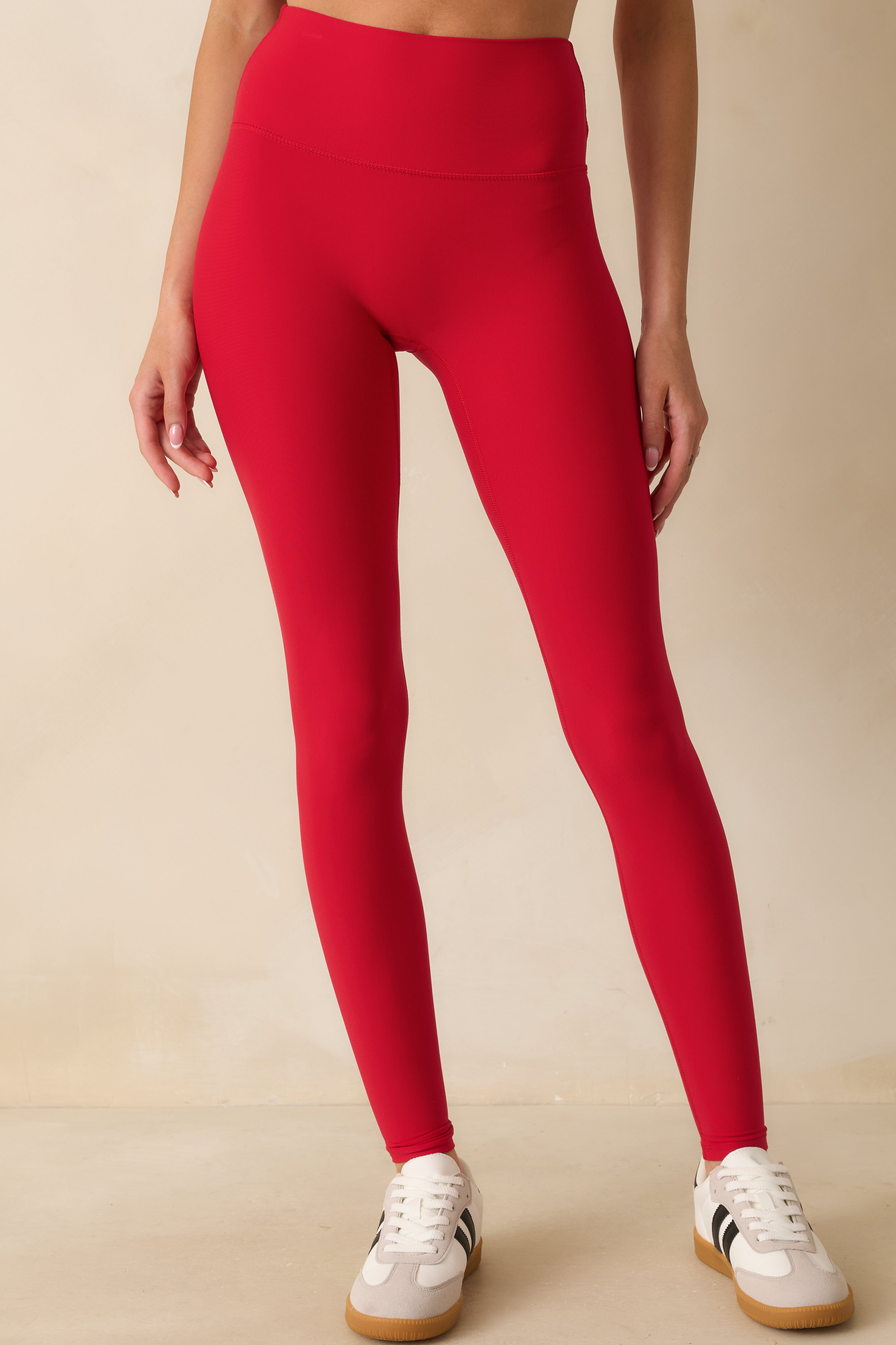 Red leggings highlighting the flattering back seam detail and sleek, buttery-soft material