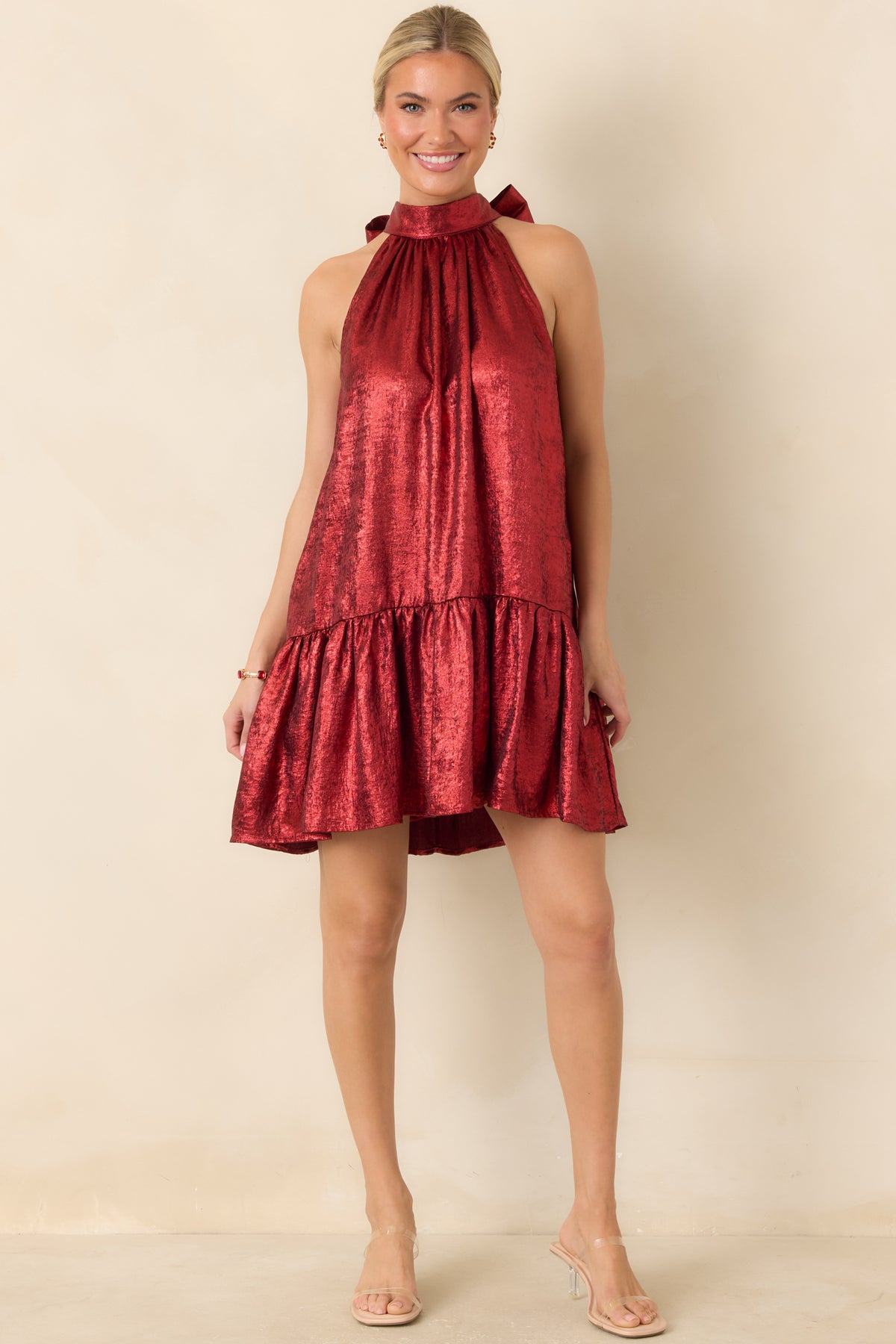 Lustrous red mini dress with a flowing A-line shape, wide ruffle trim, and elegant halter neckline.