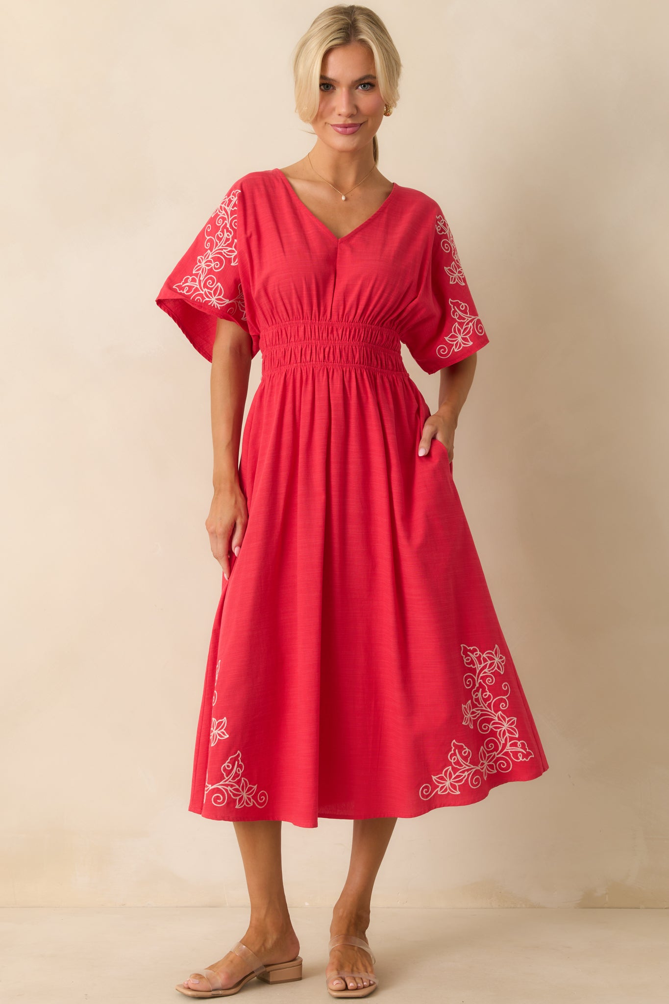 Red midi with functional pockets and elastic waistline for comfort.