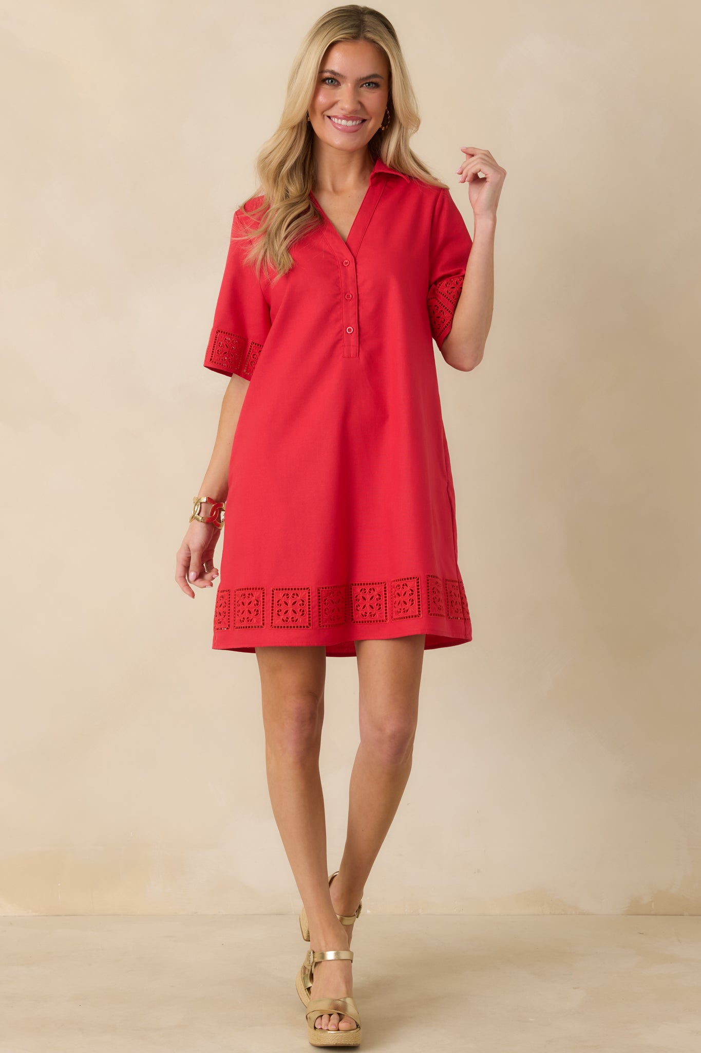 Front view of a red mini dress with a collared neckline, partial button-front closure, and structured shirt-dress silhouette.