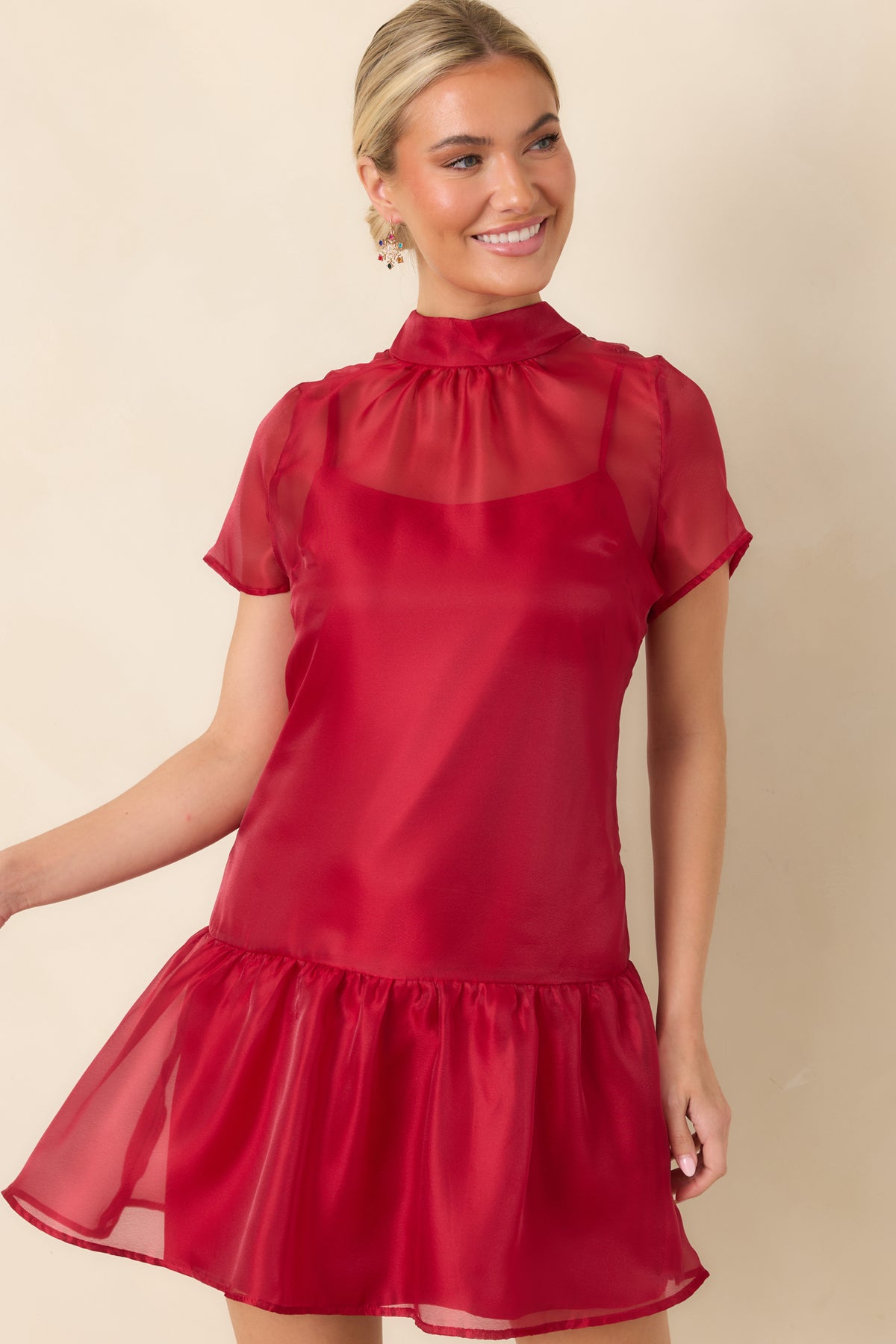 Red mini dress with a mock neckline that ties into an oversized bow at the back.
