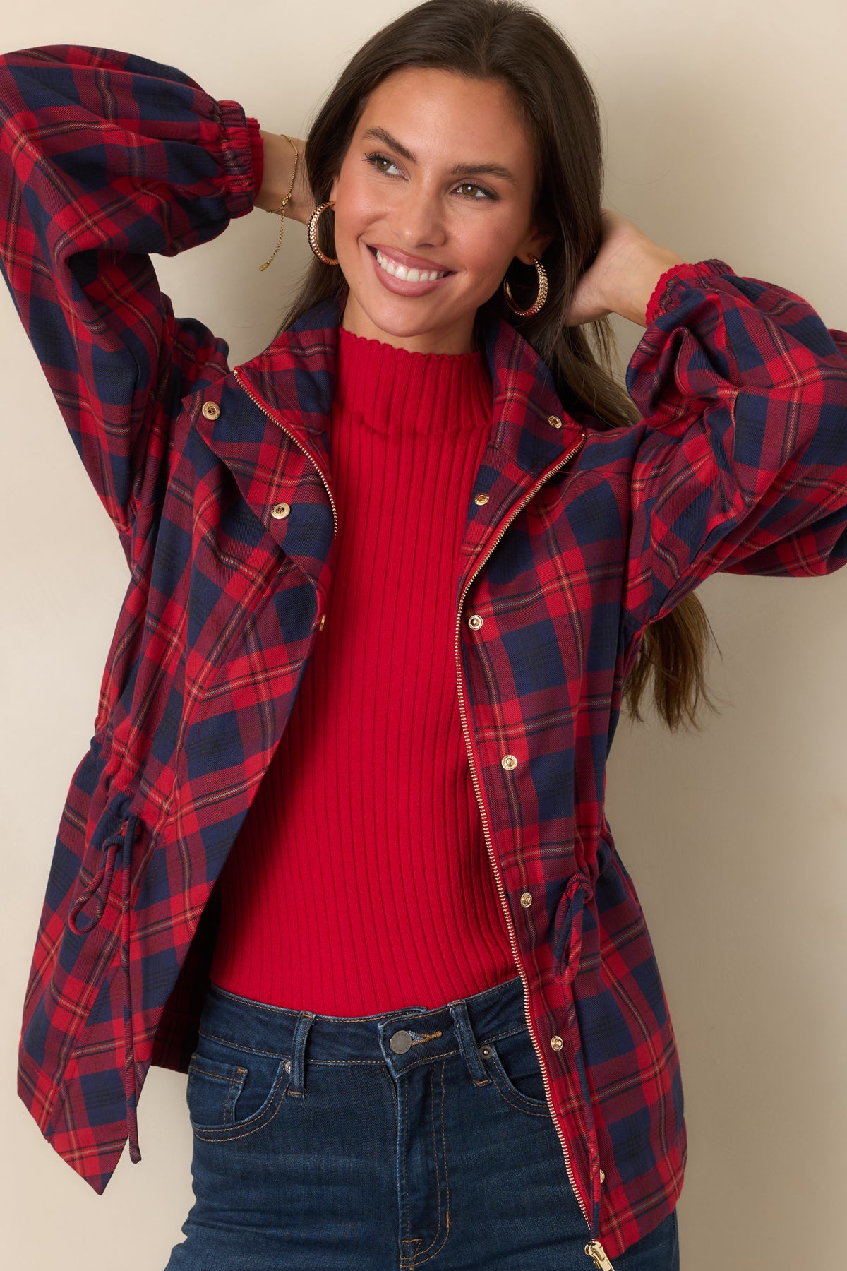 Plaid jacket highlighting its zip-front closure, structured collar, and oversized utility pockets.