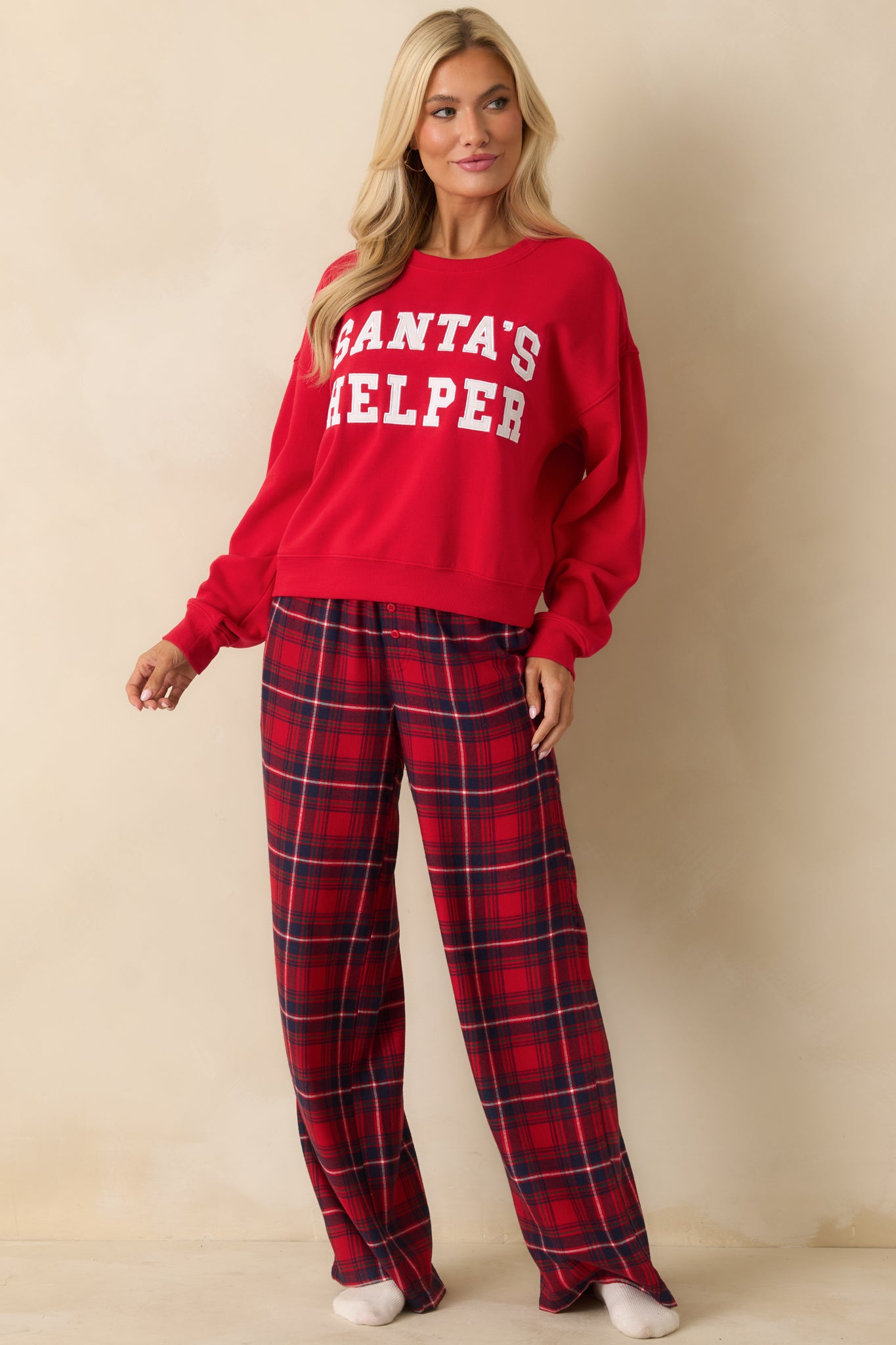 Red oversized sweatshirt in midweight fleece with a crew neckline, long sleeves, and twill “Santa’s Helper” applique on the front.