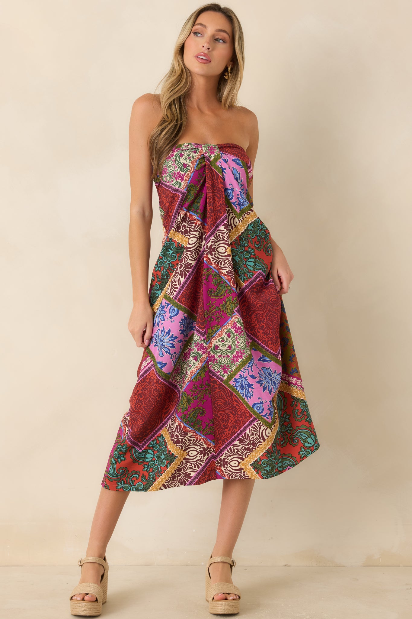 Red patchwork print midi dress with a strapless neckline and softly flowing skirt for an effortless, feminine silhouette.