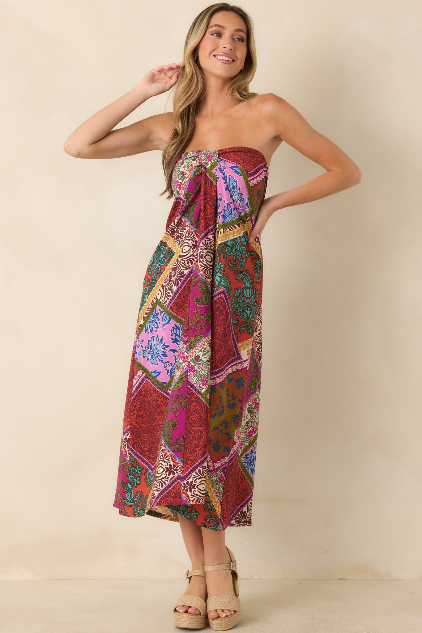 Red multi patchwork print midi dress featuring a strapless neckline, flowy silhouette, and front box pleat detail.