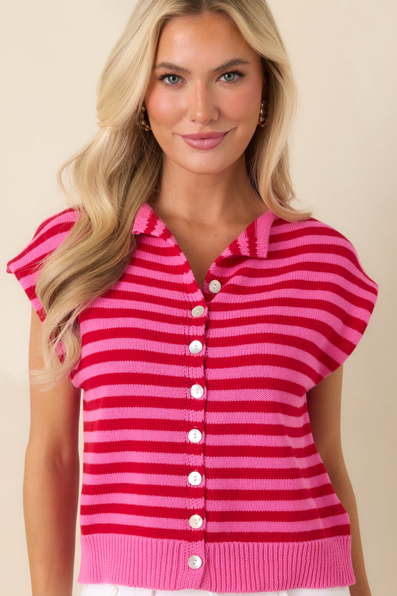 Red and pink striped shirt showcasing the button-front closure, cap sleeves, and soft knit fabric.