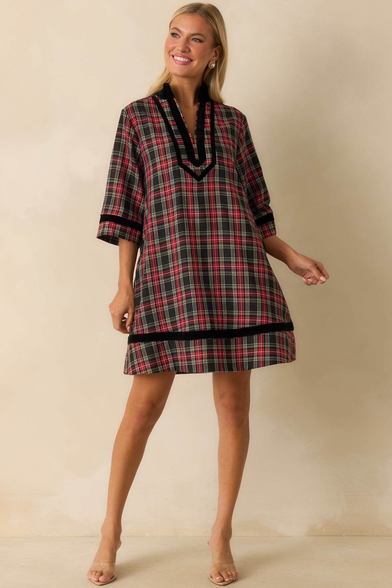 A-line red plaid mini dress with fully lined construction, soft woven texture, and black velvet trim accents.