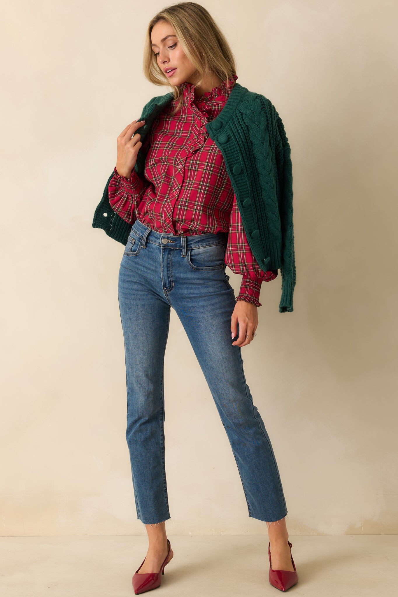 Red plaid blouse with a button-up front, ruffled neck detail, and long puff sleeves with smocked cuffs.