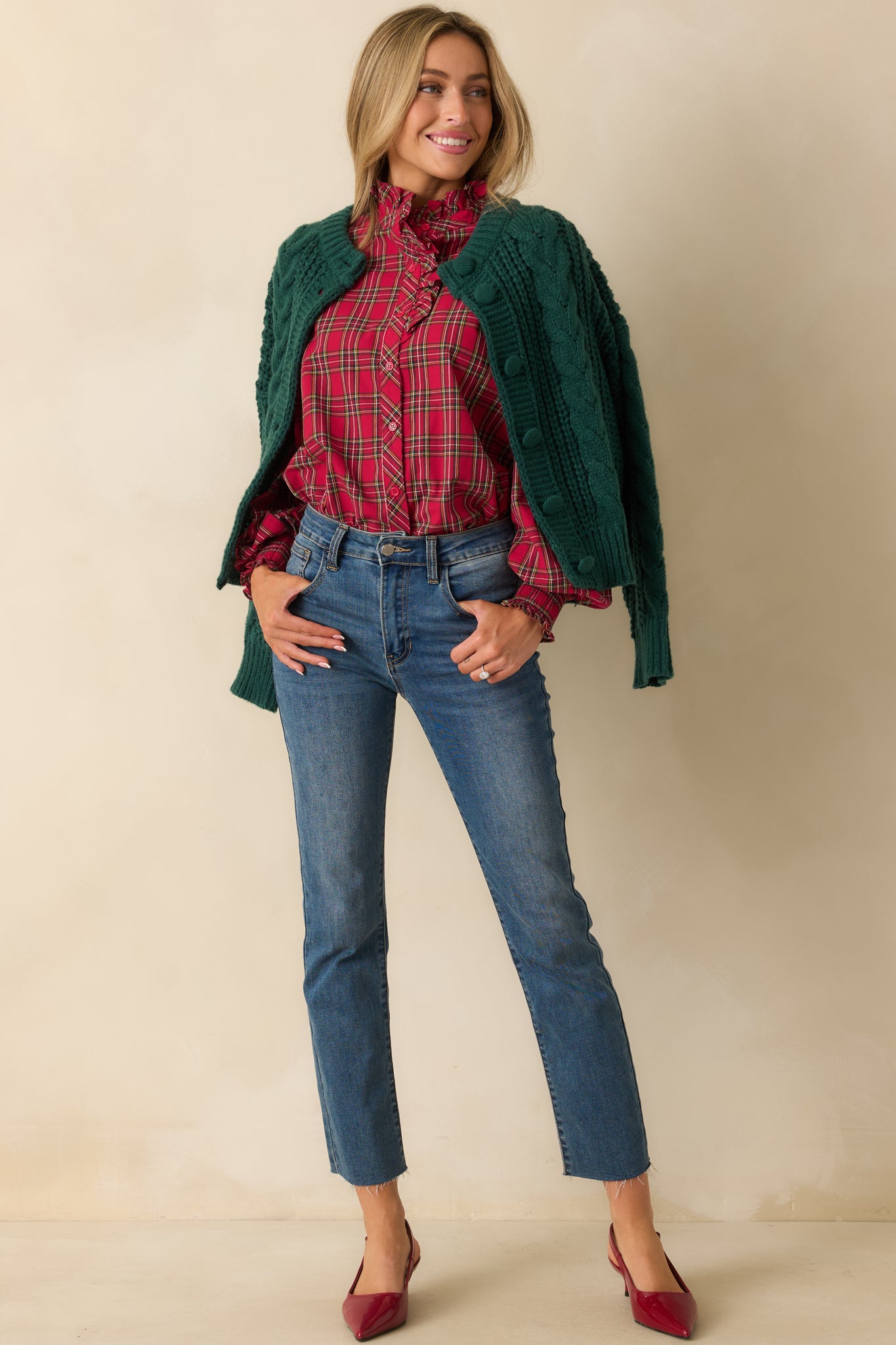 Button-up red plaid blouse with a ruffle neckline and soft, flowing puff sleeves for a polished look.